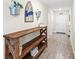 Stylish entryway with a rustic wooden console table and modern decor at 4718 Magnetite Loop, Mount Dora, FL 32757