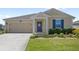 Charming single-story home with a well-manicured lawn and a welcoming front porch at 4718 Magnetite Loop, Mount Dora, FL 32757
