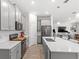Modern kitchen with stainless steel appliances, white countertops and large island at 4718 Magnetite Loop, Mount Dora, FL 32757