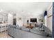Cozy living room connected to kitchen featuring a large TV and comfortable sectional sofa at 4718 Magnetite Loop, Mount Dora, FL 32757