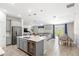 Bright, open-concept living space featuring a modern kitchen island and comfortable seating at 4718 Magnetite Loop, Mount Dora, FL 32757
