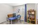Study room with blue desk, chair, and bookcase at 4718 Magnetite Loop, Mount Dora, FL 32757