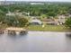 Aerial shot of a lakeside home featuring a screened lanai and backyard leading to the water at 720 Basin Dr, Kissimmee, FL 34744