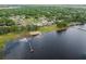 Scenic aerial view highlighting waterfront properties, docks, and a tranquil lake surrounded by lush landscapes at 720 Basin Dr, Kissimmee, FL 34744