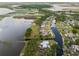 Stunning aerial view featuring waterfront homes along a canal leading to a picturesque lake at 720 Basin Dr, Kissimmee, FL 34744