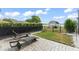 Backyard with patio, lounge chairs, and fenced-in lawn at 720 Basin Dr, Kissimmee, FL 34744