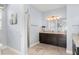 Bathroom with granite countertops, dark cabinets, and a walk-in shower at 720 Basin Dr, Kissimmee, FL 34744