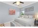 Bright bedroom with soft color scheme and ceiling fan with bench at foot of bed at 720 Basin Dr, Kissimmee, FL 34744