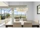Dining room with modern chandelier and sliding glass doors leading to outdoor living at 720 Basin Dr, Kissimmee, FL 34744