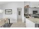 Open floorplan of a kitchen leading to dining room featuring granite countertops and stainless steel appliances at 720 Basin Dr, Kissimmee, FL 34744