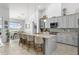 Beautiful kitchen with granite counters, island seating, and views of the dining area at 720 Basin Dr, Kissimmee, FL 34744