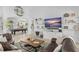 Spacious living room with mounted TV, tile flooring, billiards table, and elegant decor at 720 Basin Dr, Kissimmee, FL 34744