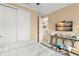 Bedroom featuring double closets, adjacent doorway, television and console table at 720 Basin Dr, Kissimmee, FL 34744
