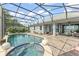 This screened in pool and hot tub area has beautiful views and ample lounge seating at 720 Basin Dr, Kissimmee, FL 34744