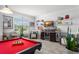 Well-lit recreation room showcasing a pool table, bar area, and comfortable seating at 720 Basin Dr, Kissimmee, FL 34744