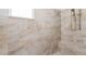 Walk-in shower with horizontal marbled tile and overhead shower head at 720 Basin Dr, Kissimmee, FL 34744