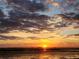 Beautiful lake view at sunset, displaying picturesque orange, yellow, and blue skies at 720 Basin Dr, Kissimmee, FL 34744