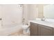 Bathroom featuring a shower-tub, gray vanity, and tile flooring at 7435 Groveoak Dr, Orlando, FL 32810