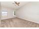 Comfortable carpeted bedroom with large windows and a ceiling fan at 7435 Groveoak Dr, Orlando, FL 32810