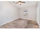 Cozy bedroom with neutral paint, carpet, ceiling fan, and window for natural light at 7435 Groveoak Dr, Orlando, FL 32810