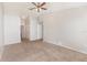 Spacious carpeted bedroom with ceiling fan, features neutral walls and multiple closets at 7435 Groveoak Dr, Orlando, FL 32810