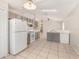 Functional kitchen area features ample counter space and essential appliances with tile floors at 7435 Groveoak Dr, Orlando, FL 32810