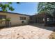 Home exterior featuring a covered patio and a stone-paved outdoor living space at 769 Little Wekiva Cir, Altamonte Springs, FL 32714