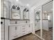 Bright bathroom with a subway-tiled shower and a double vanity with black fixtures and hardware at 769 Little Wekiva Cir, Altamonte Springs, FL 32714
