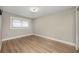 Bedroom features a window with blinds, neutral paint, and modern lighting fixture at 769 Little Wekiva Cir, Altamonte Springs, FL 32714