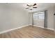 Bedroom featuring hardwood floors, neutral paint, and a window with light-filtering shades at 769 Little Wekiva Cir, Altamonte Springs, FL 32714