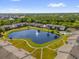 Aerial view showcasing a pond, pool, and walkways of a residential community at 8217 Sun Spring Cir # 41, Orlando, FL 32825