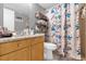 Bathroom featuring a floral shower curtain, a granite countertop vanity, and open shelving at 8217 Sun Spring Cir # 41, Orlando, FL 32825