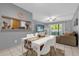 Cozy dining room with a white table, seating for four, and an open kitchen view at 8217 Sun Spring Cir # 41, Orlando, FL 32825