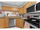 Well-lit kitchen features wooden cabinetry, granite countertops, and modern stainless steel appliances at 8217 Sun Spring Cir # 41, Orlando, FL 32825