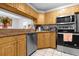 Bright kitchen featuring stainless steel appliances, wooden cabinets, and tile floors at 8217 Sun Spring Cir # 41, Orlando, FL 32825