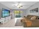 Comfortable living room with natural light, modern decor, and tile flooring at 8217 Sun Spring Cir # 41, Orlando, FL 32825