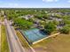 Aerial view of community tennis courts available to residents surrounded by lush trees and landscaping at 8217 Sun Spring Cir # 41, Orlando, FL 32825