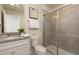 Bright bathroom with a walk-in shower, granite countertops, and a modern vanity with a sink at 977 Paradise Dr, Davenport, FL 33897