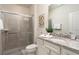 Bright bathroom with a walk-in shower, granite countertops, and a modern vanity at 977 Paradise Dr, Davenport, FL 33897