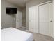 Modern bedroom featuring carpet floors, a television, and a double door closet at 977 Paradise Dr, Davenport, FL 33897