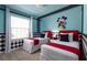 The bedroom features two twin beds with a cartoon theme and a Mickey Mouse wall decoration at 977 Paradise Dr, Davenport, FL 33897