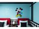 Close up of a bedroom with two twin beds with a cartoon theme and a Mickey Mouse wall decoration at 977 Paradise Dr, Davenport, FL 33897