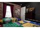 A bedroom with two twin beds features Harry Potter themed decorations, brick walls, and a TV at 977 Paradise Dr, Davenport, FL 33897