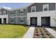 Charming two-story townhouse with well-manicured lawn and inviting facade at 977 Paradise Dr, Davenport, FL 33897