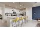Modern kitchen with white cabinetry, stainless steel appliances, and a center island with seating at 977 Paradise Dr, Davenport, FL 33897