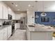 Bright kitchen featuring granite counters, white cabinets, and modern stainless steel appliances at 977 Paradise Dr, Davenport, FL 33897