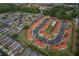 An aerial view displays a community featuring a pool, bordered by colorful homes, lakes, and green spaces at 979 Park Terrace Cir, Kissimmee, FL 34746