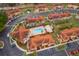 Overhead view showcasing a pool area nestled within a community of colorful homes and ample parking at 979 Park Terrace Cir, Kissimmee, FL 34746