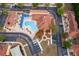 A serene aerial shot features a resort-style pool, surrounded by condos, landscaping, and ample parking spaces at 979 Park Terrace Cir, Kissimmee, FL 34746