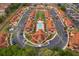 Aerial view showcasing community layout, centralized pool, colorful buildings, parking, and lush landscaping at 979 Park Terrace Cir, Kissimmee, FL 34746